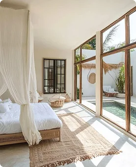Sunlit bedroom looking onto a private pool